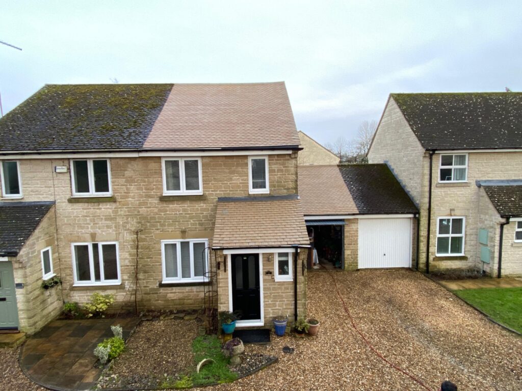 Professional roof cleaning service in West London removing moss and dirt